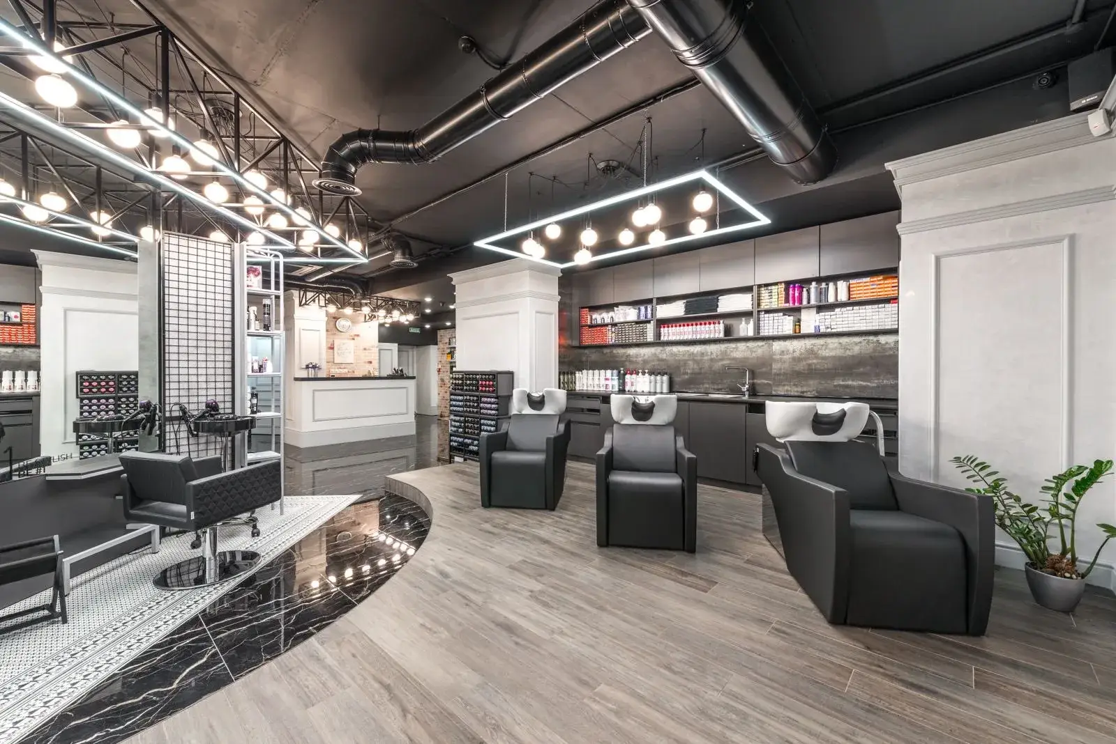 A bright, empty salon floor in the morning — chairs ready, lights on